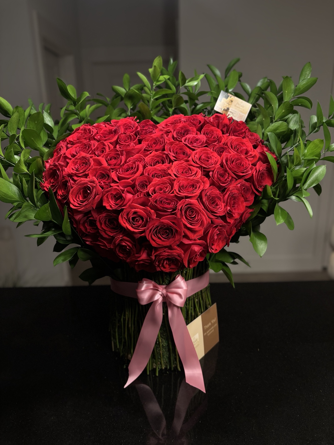 Close detail of red rose heart stand