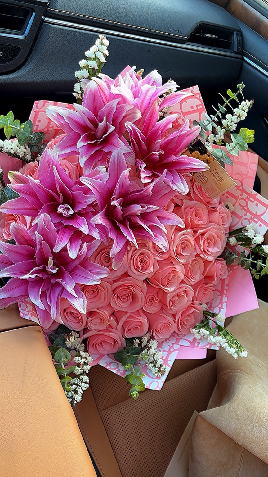 Pink lilies and roses in a custom wrapped bouquet