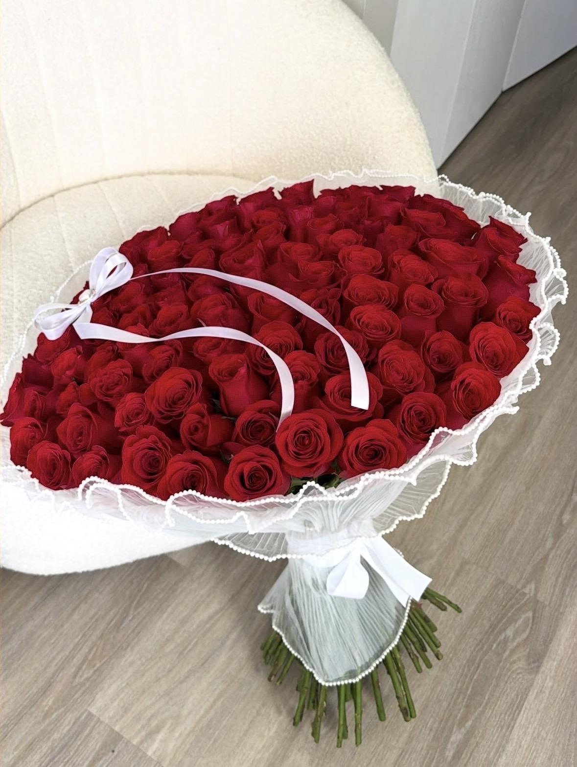 Large red rose bouquet wrapped in white pearl trim